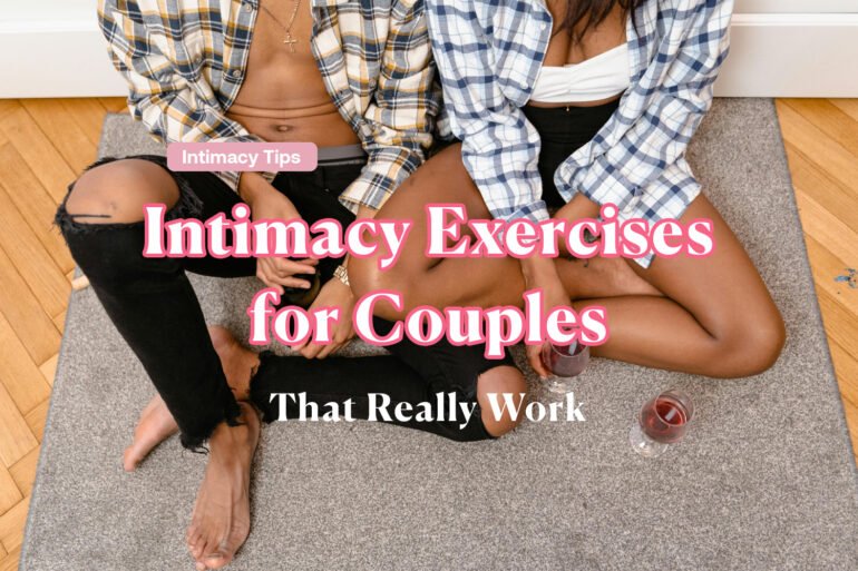 A cozy couple sitting cross-legged on a pastel rug, holding hands and smiling warmly.