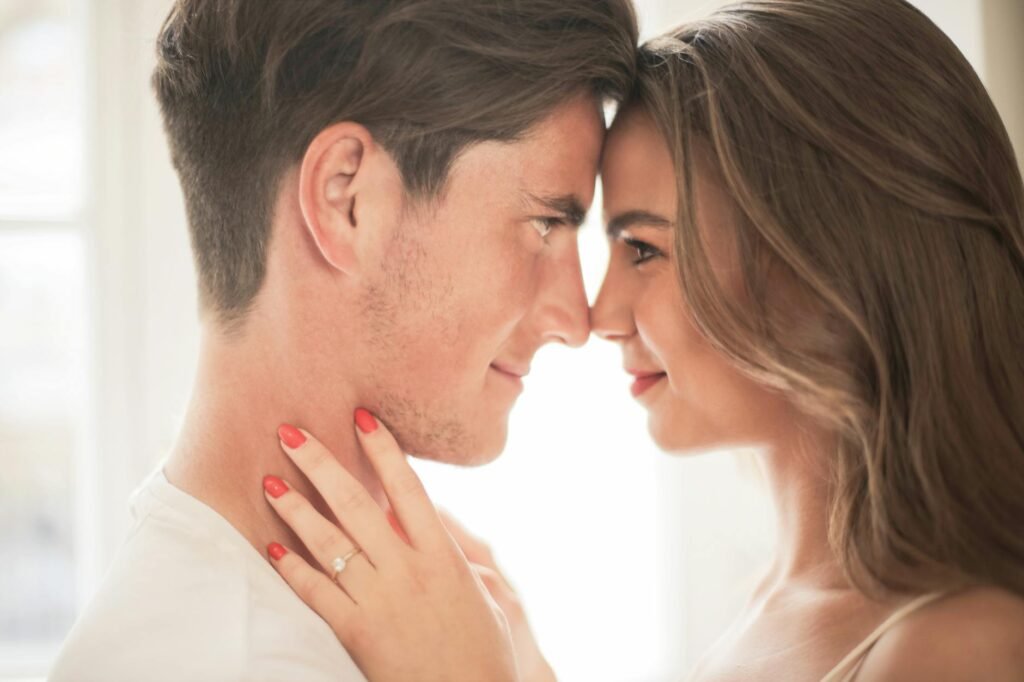 close up photo of hugging couple facing each other while smiling
