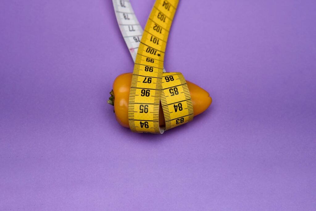 deon-black-sUV1sfS8p00-unsplash minimal flat-lay of a flexible tape measure around a cylinder (PG-safe).